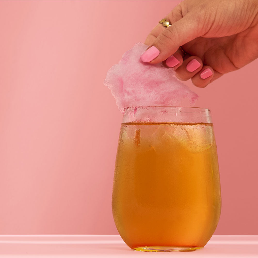 Baby Spice Iced Tea Mocktail With Candy Floss Topper & Hand Picking Up Candy Floss