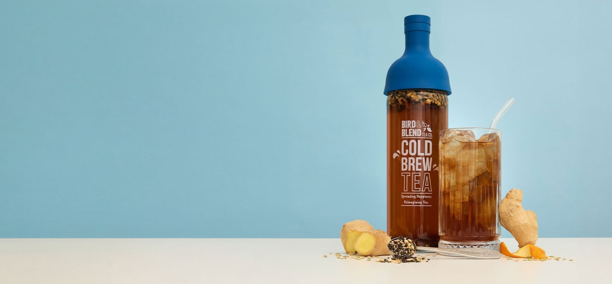 The digester iced cold brew tea & cold brew tea bottle sapphire blue & ginger & spoon filled with loose leaf tea