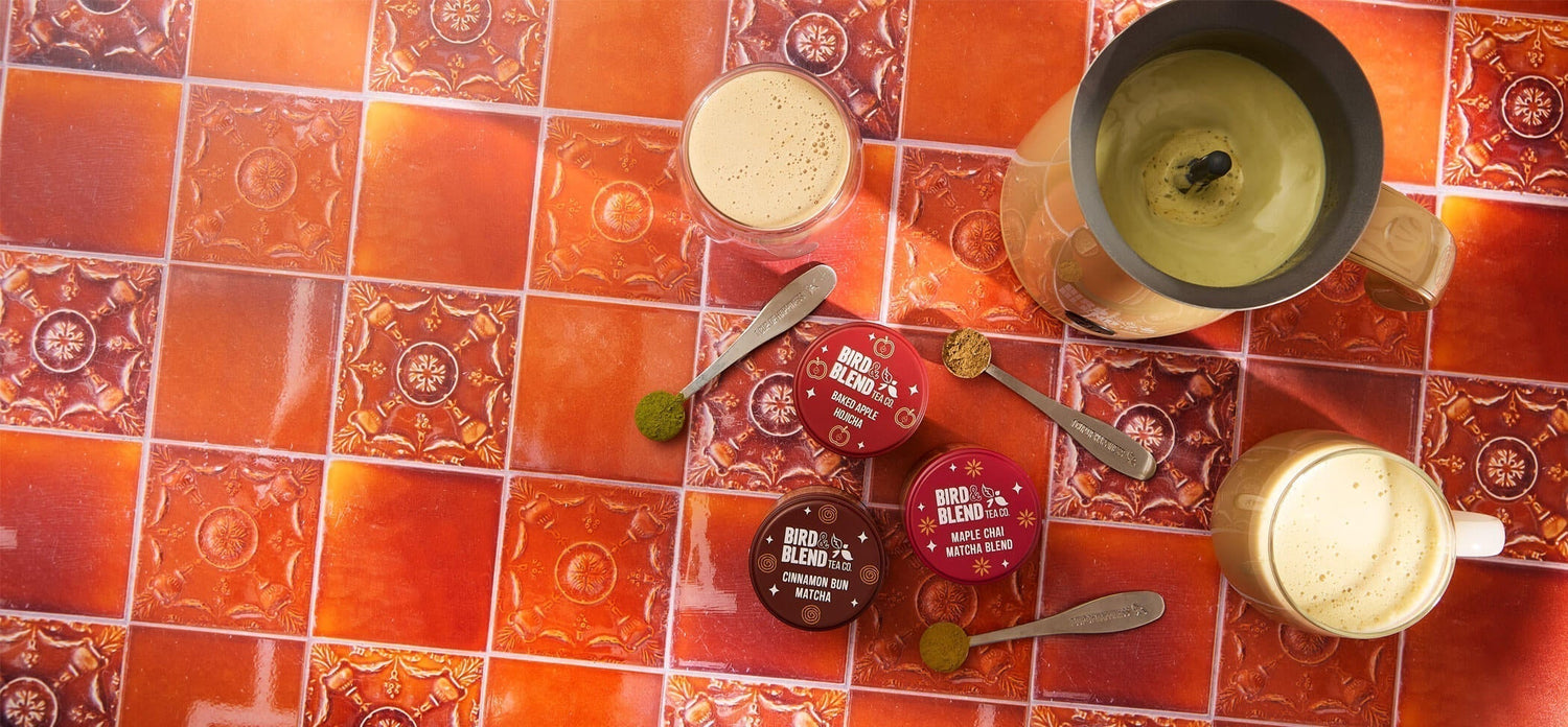 cinnamon bun matcha tea baked apple hojicha tea powder & maple chai matcha blend tin & spoons filled with matcha & tea powder & cups & mugs filled with matcha & bamboo matcha latte magic whisk filled with matcha