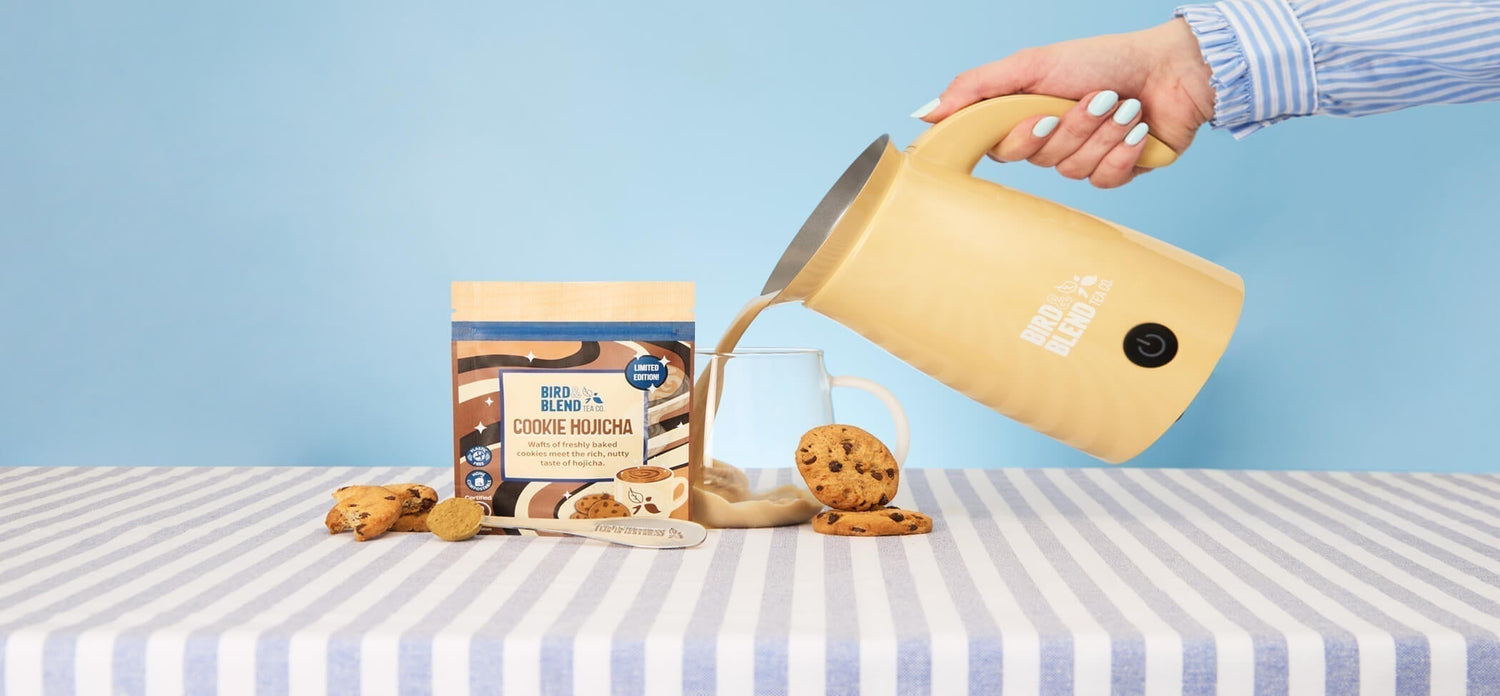 Cookie Hojicha Tea Powder and spoon and hot tea latte pouring from bamboo gloss magic latte whisk