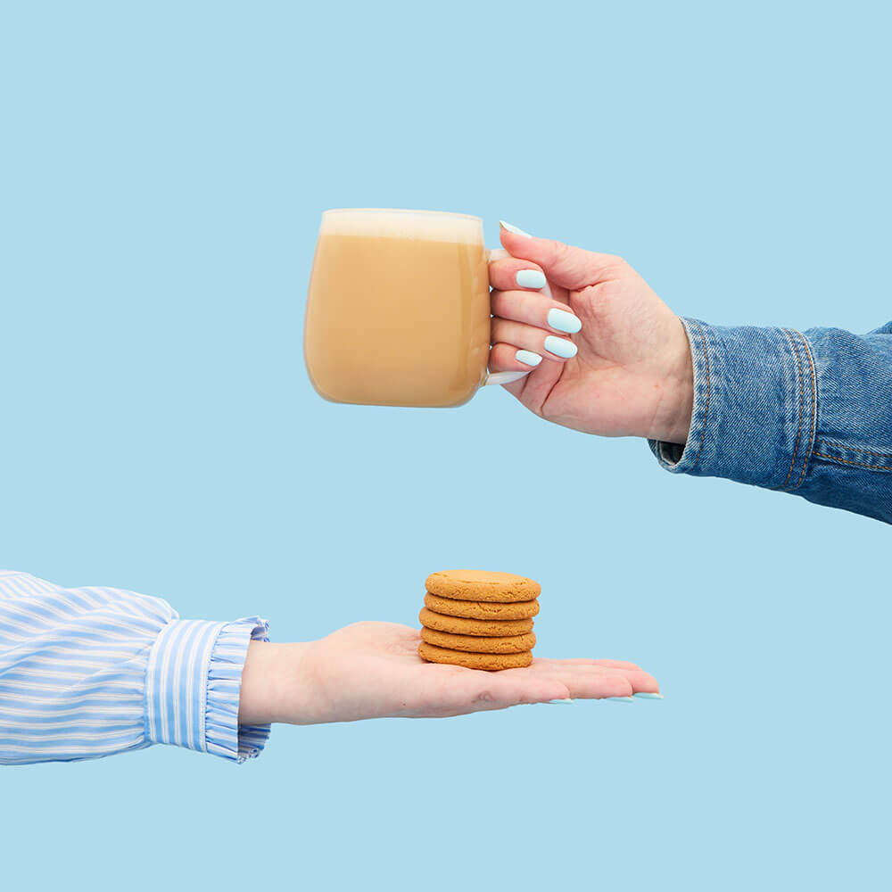 gingernut biscuit hot tea latte in mug and gingernut biscuits