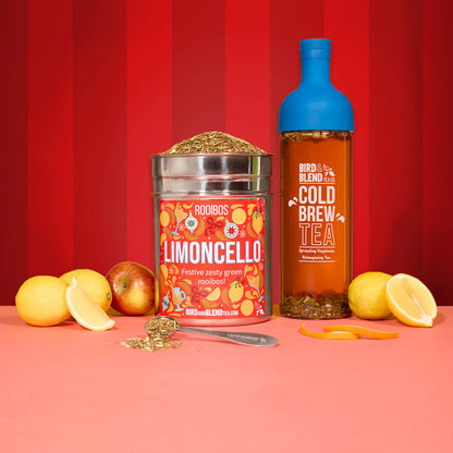 limoncelllo tea wall tin and spoon filled with loose leaf and cold brew tea bottle in sapphire blue filled with tea