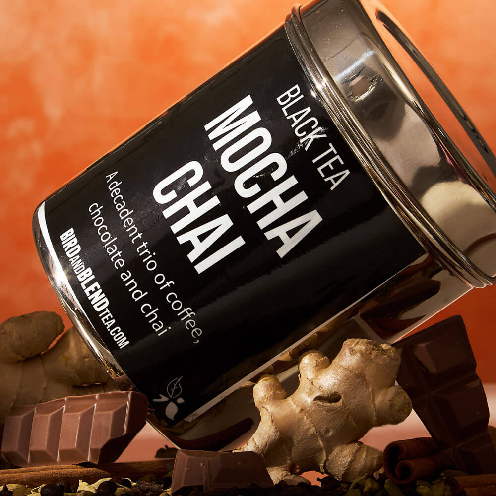 mocha chai custom loose leaf tea tin laying side ways on chocolate &amp; ginger &amp; spices