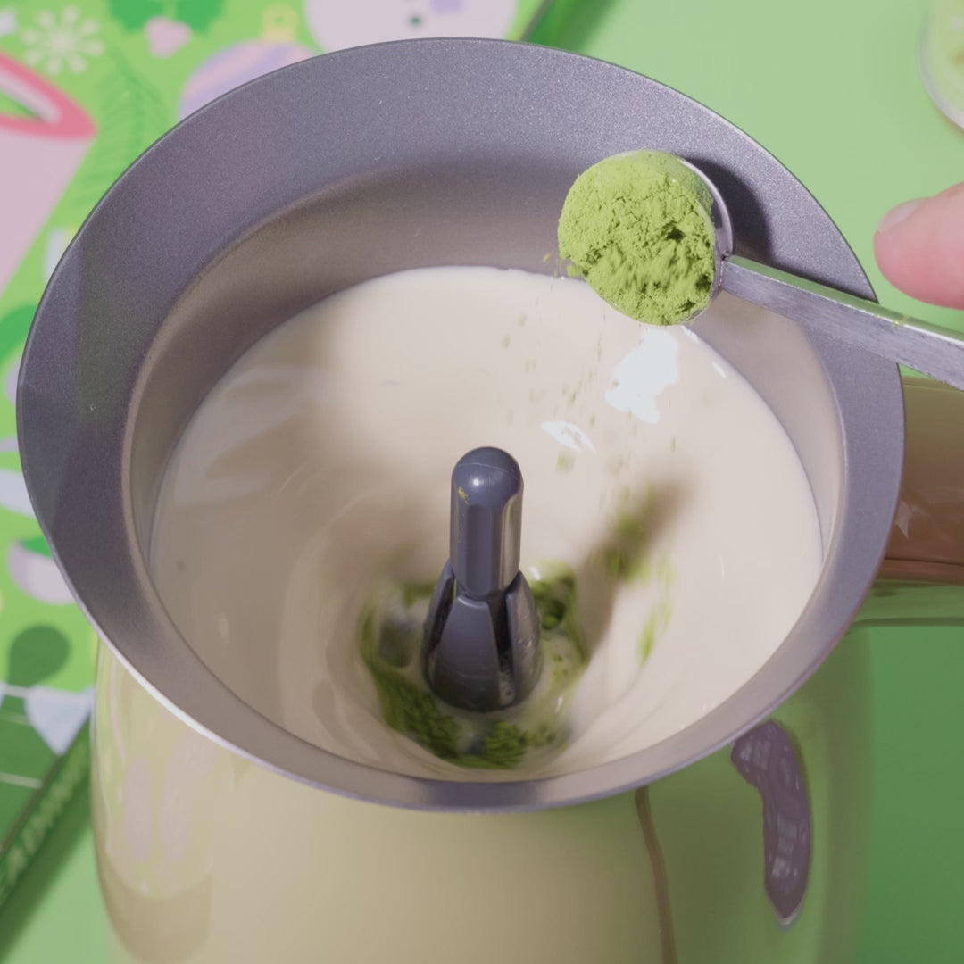 matcha advent matcha tea spoon pouring into matcha whisk with matcha advent calendar