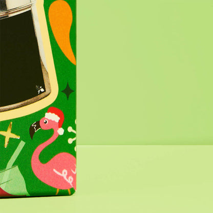 side of cube with half of a black custom tea tin &amp; flamingo graphic with santa hat on