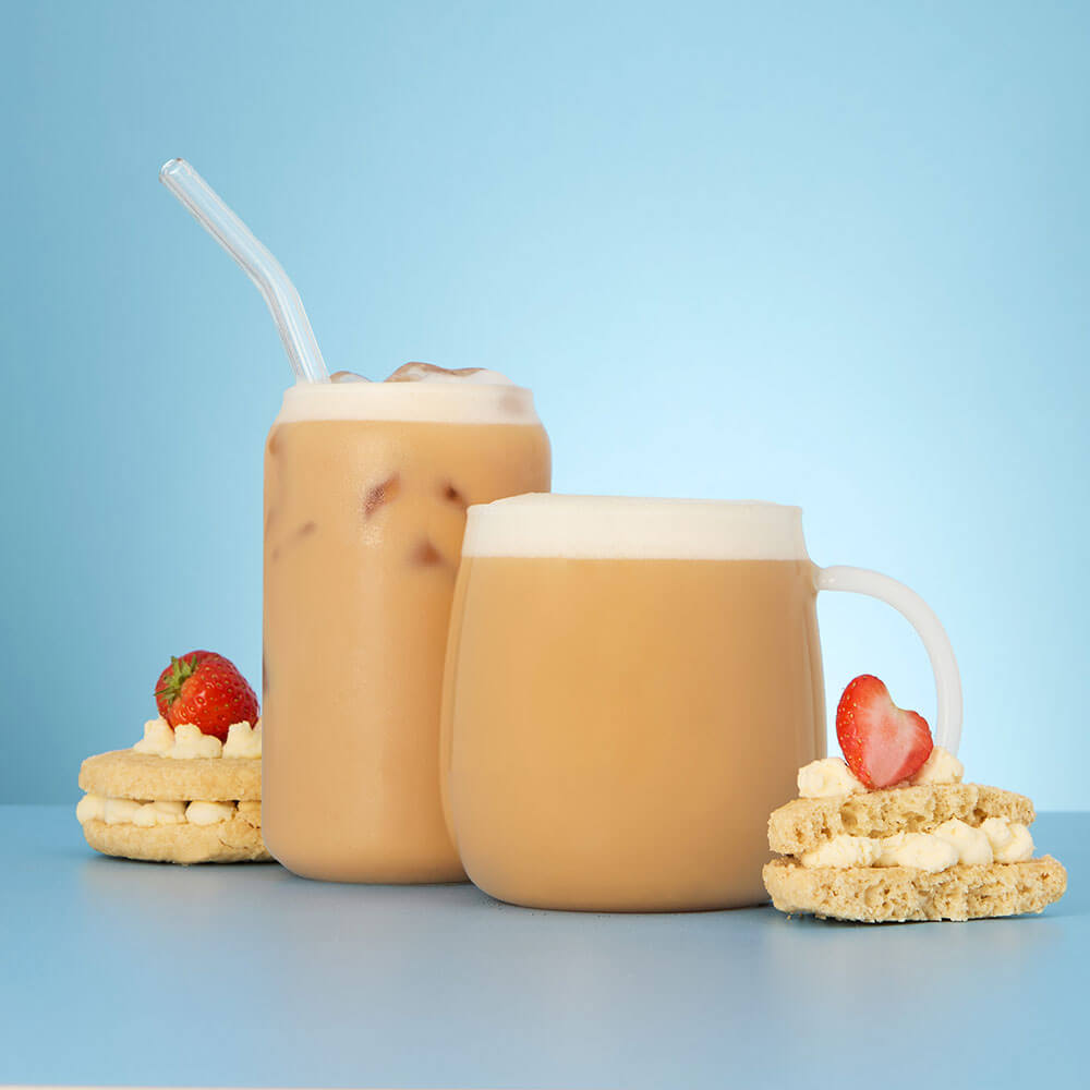 strawberry shortcake biscuit and strawberry shortcake hot and iced tea latte in a glass cup and mug