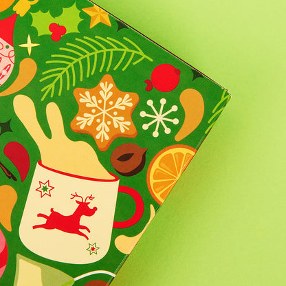 tea advent calendar close up on tea mugs spilling tea graphics &amp; Christmas ingredients &amp; ornaments. 